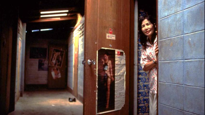 A sex worker stands in a doorway at Shipha House, a Brothel near the main bus terminal in the town of Phayao in northern Thailand.