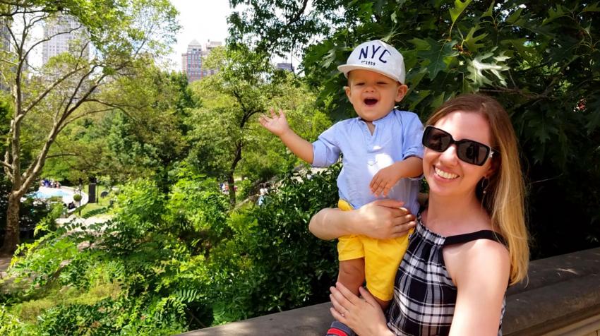 Photo of Sarah holding her son, Issac, as they pose for a photo in a park
