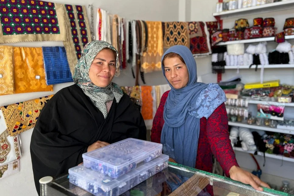 Shahrbanoo and Motahera stand in their store.
