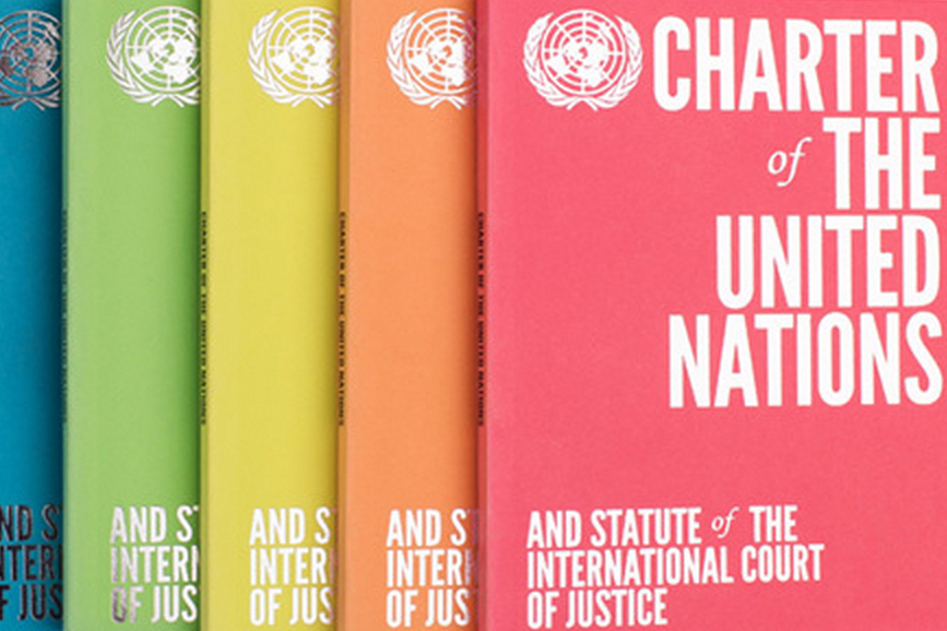 Copies of the UN Charter on a table.