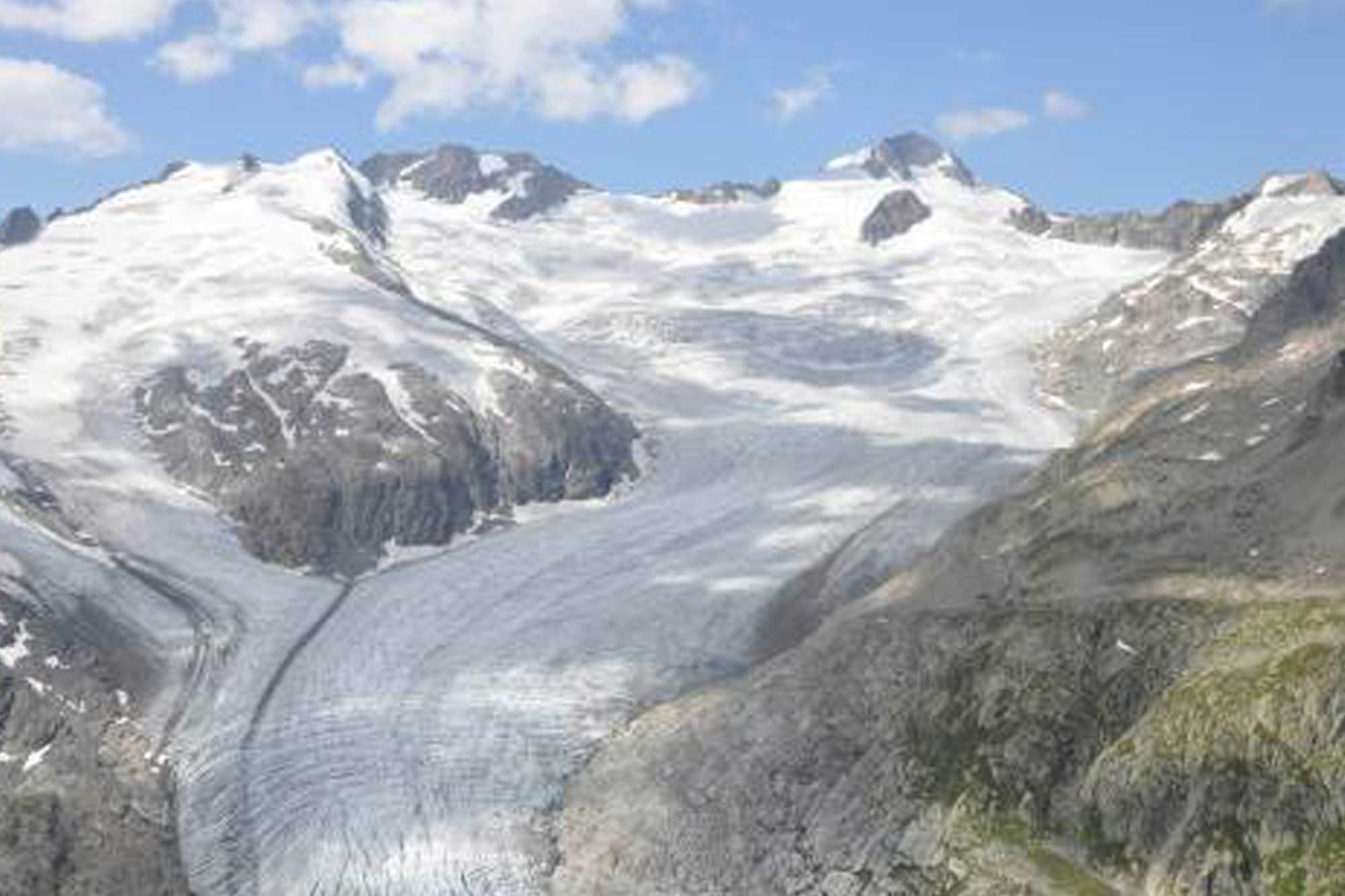 Aerial view of glacier that is melting down mountains.