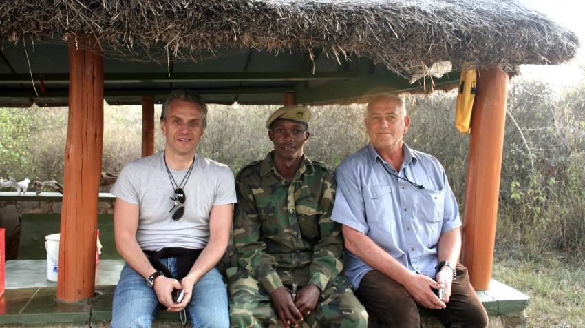 Ilias Chatzis and two colleagues sitting under straw shelter