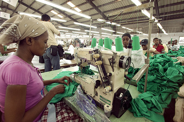 A seamstress sews a garment in a "Multiwear" factory at the Sonapi industrial park.
