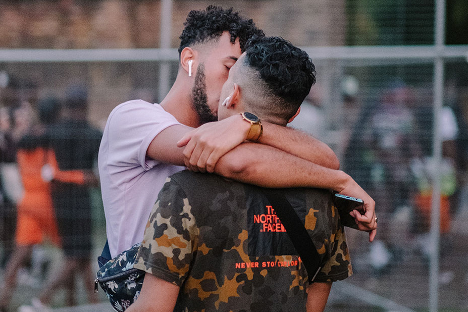 Two people kissing at Black Pride, UK.