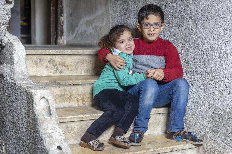 Syrian children sitting on steps