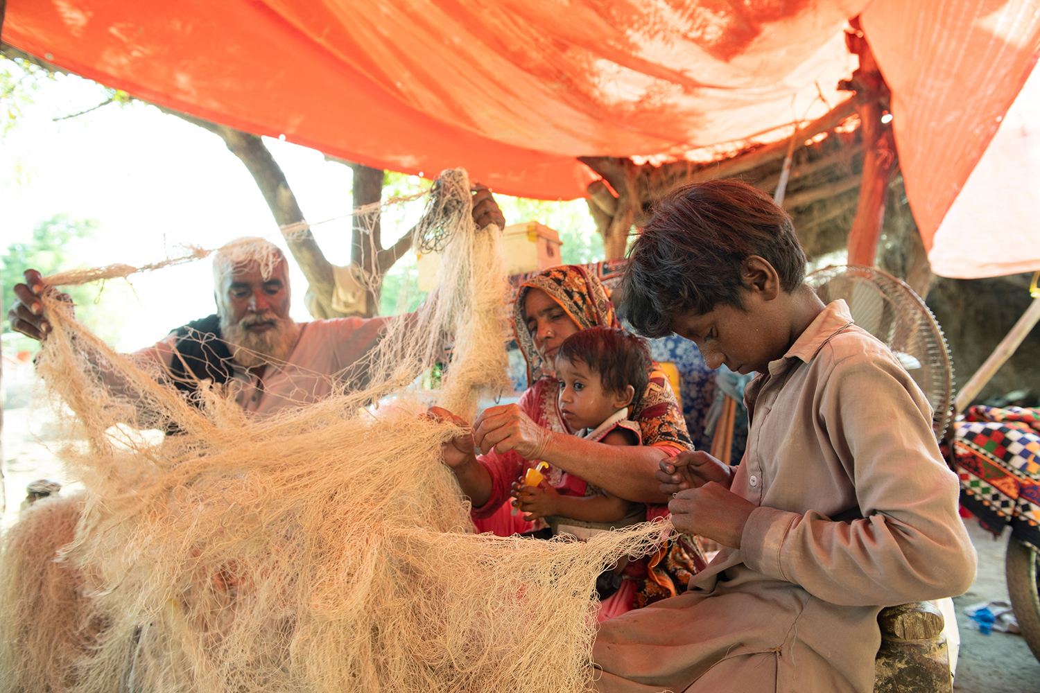 fisherman's family fixing up nets